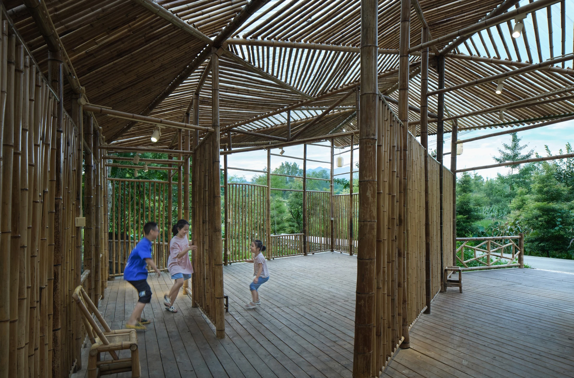 Children spending time inside the open bamboo structure at Ma’s Bamboo Workshop