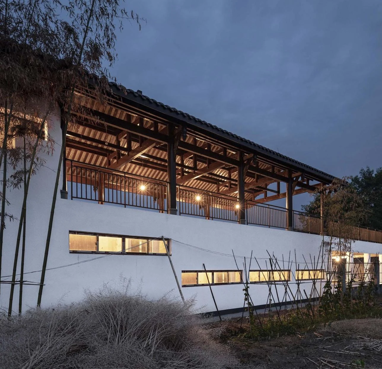 Nanxi Yao at dusk, with a sheltered upper veranda above white walls