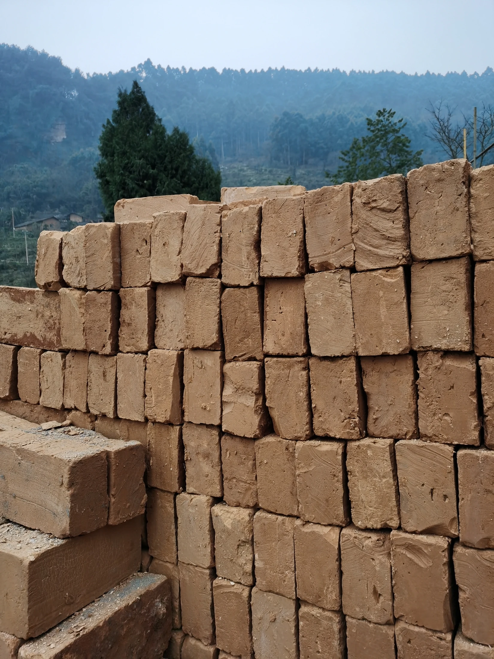 Stacked earth bricks showing their individual shapes and textured surfaces